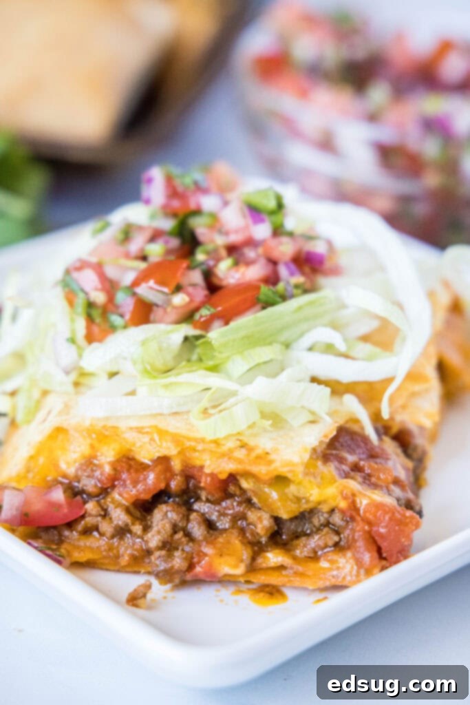 sheet pan taco slice on a plate with taco toppings