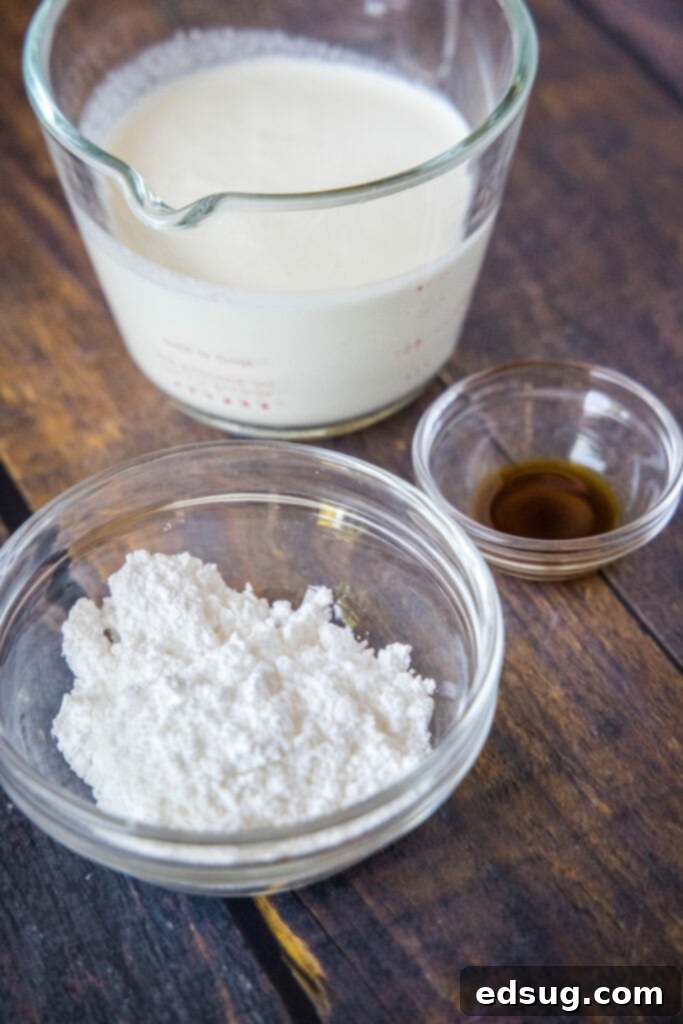 Fluffy Homemade Whipped Cream 3 whipped cream ingredients laid out, including heavy cream, powdered sugar, and vanilla extract