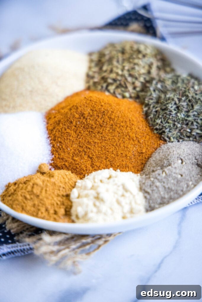 Bring the Bayou Home: Homemade Cajun Blend 3 A selection of individual spices neatly arranged on a white plate, showcasing the ingredients for homemade Cajun seasoning.