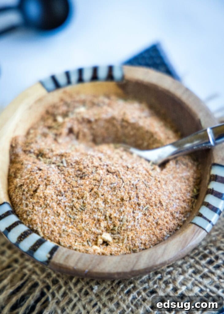 Bring the Bayou Home: Homemade Cajun Blend 5 Homemade Cajun seasoning displayed in a small white bowl with a wooden spoon, ready for use.