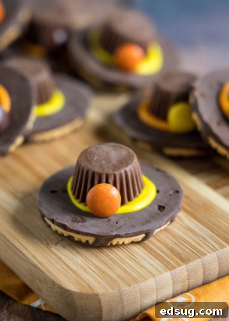 Charming Pilgrim Hat Delights 2 pilgrim hat cookie on a cutting board