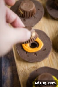 Charming Pilgrim Hat Delights 8 pipping frosting onto fudge stripe cookie