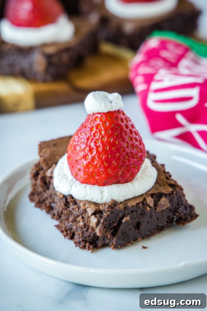 Delicious Santa Hat Brownie on a white plate, perfect for Christmas dessert.