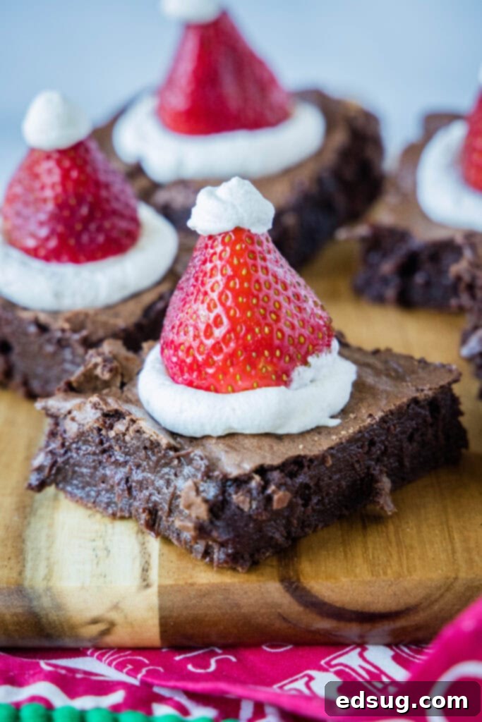 A festive display of Santa Hat Brownies arranged on a cutting board, ready for serving.