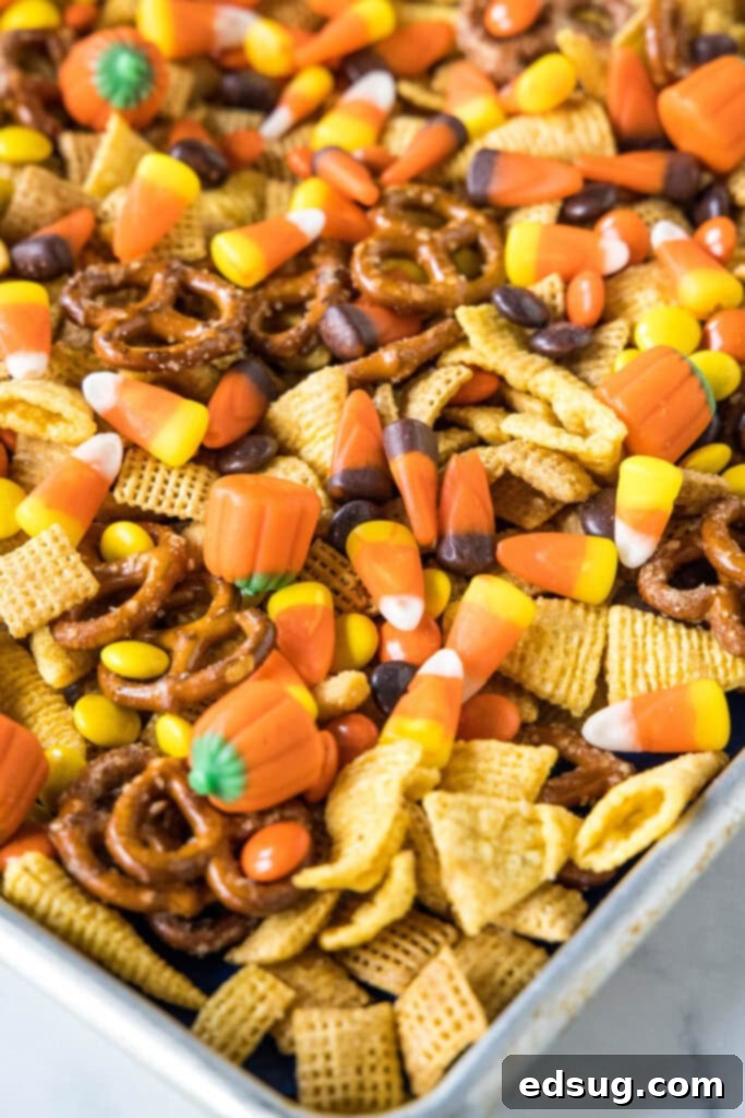 Haunted Halloween Hits 5 candy added to halloween party mix, showing colorful Reese's Pieces and candy corn
