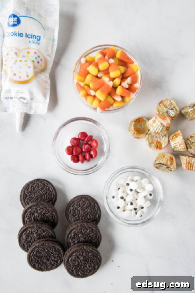 Thanksgiving Oreo Turkey Treats 3 A flat lay of the simple ingredients needed to make Oreo turkey cookies, including Oreo cookies, candy corn, Reese's peanut butter cups, candy eyes, and red M&M's.
