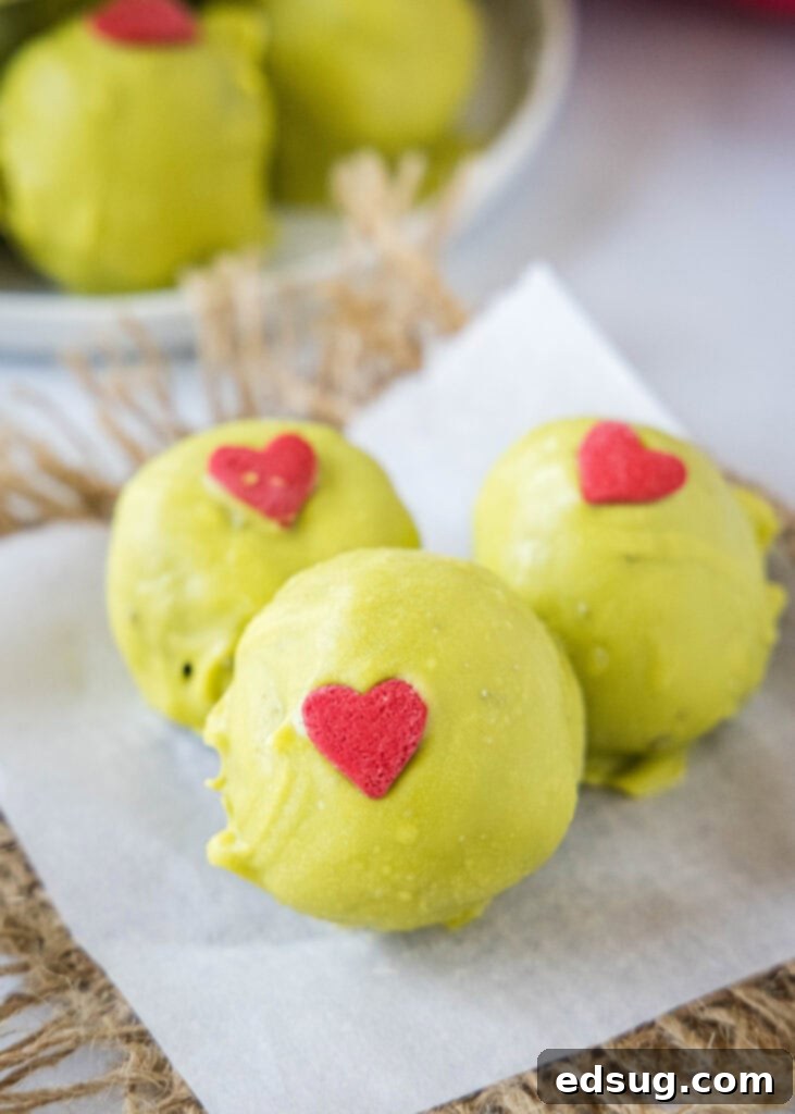 Grinch's Heart Melters 2 grinch truffles on parchment paper