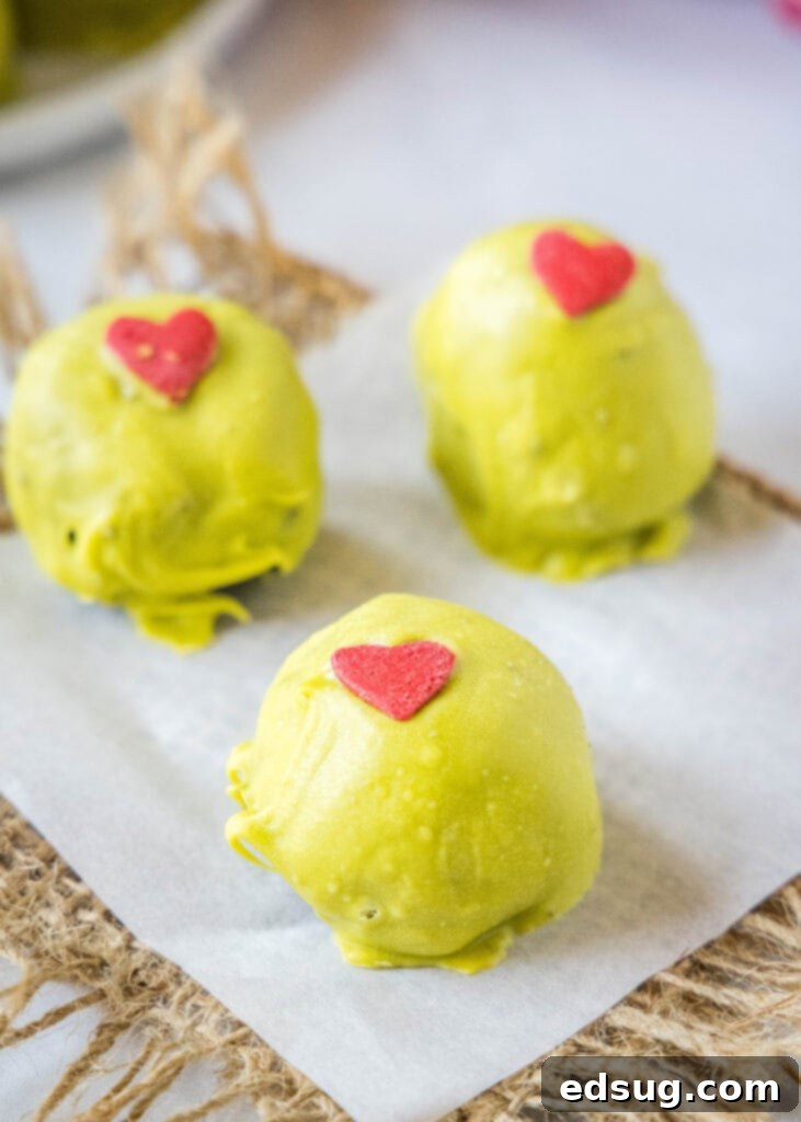 Grinch's Heart Melters 5 grinch truffles on a pieces of parchment paper