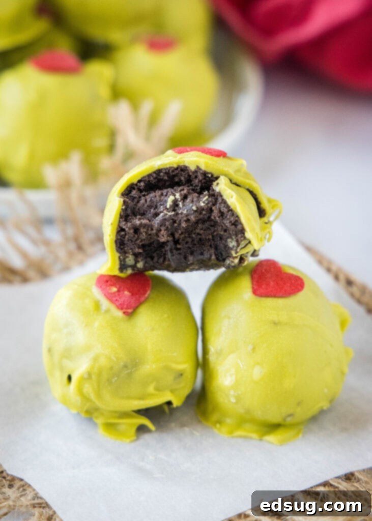 Grinch's Heart Melters 7 grinch truffles with a bite taken out of one