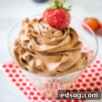 cropped close up chocolate whipped cream swirled in a glass