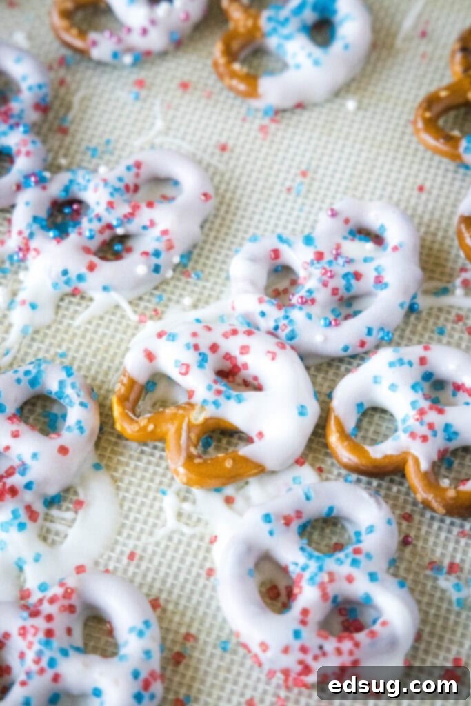 Stars and Stripes Twists 5 Close-up of white chocolate-covered pretzels adorned with colorful patriotic sprinkles.