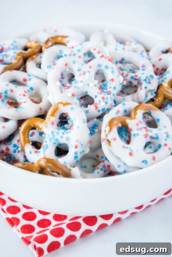 Stars and Stripes Twists 6 A charming white bowl overflowing with an assortment of patriotic pretzels, ready to be served.