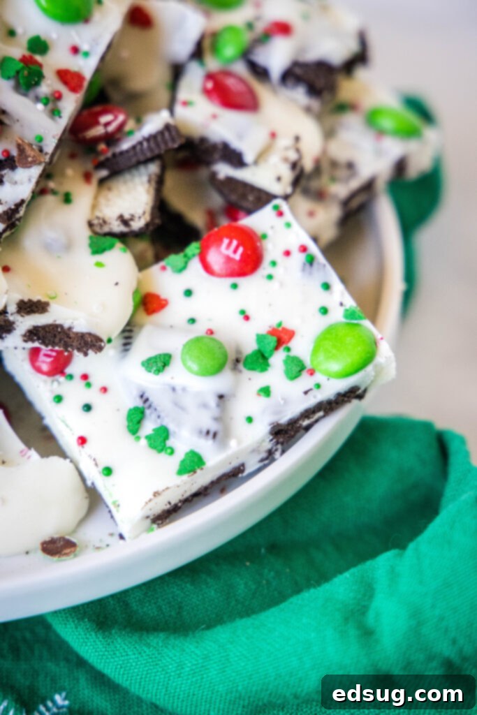 Holiday Candy Bark 6 Multiple slices of white chocolate Christmas bark artfully arranged on a white plate, showcasing the various toppings.