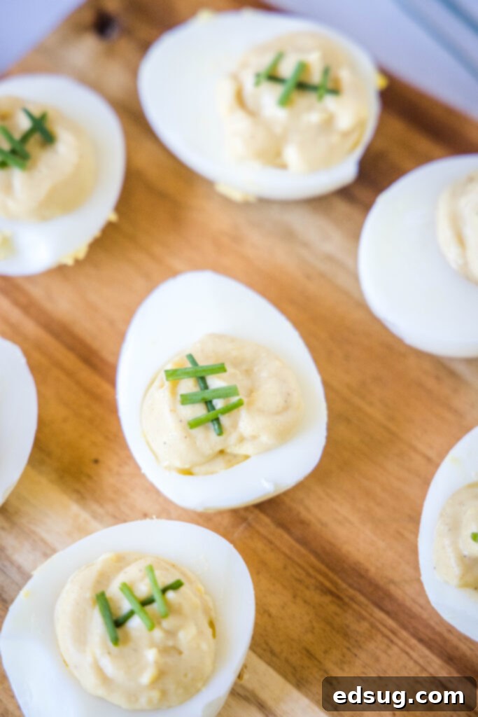 Touchdown Deviled Eggs 2 deviled eggs topped with chives to look like footballs