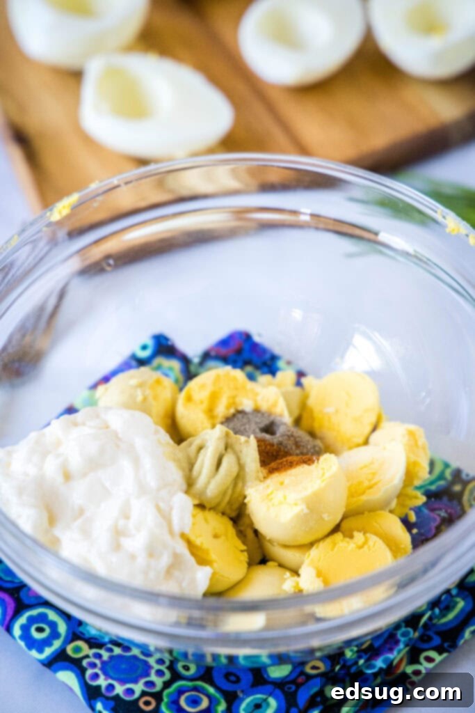 Touchdown Deviled Eggs 4 egg yolks, mayo, and spics in a bowl