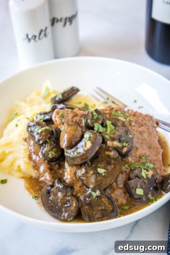 Tender Slow Cooker Cube Steak 7 cube steak with mushroom gravy over mashed potatoes