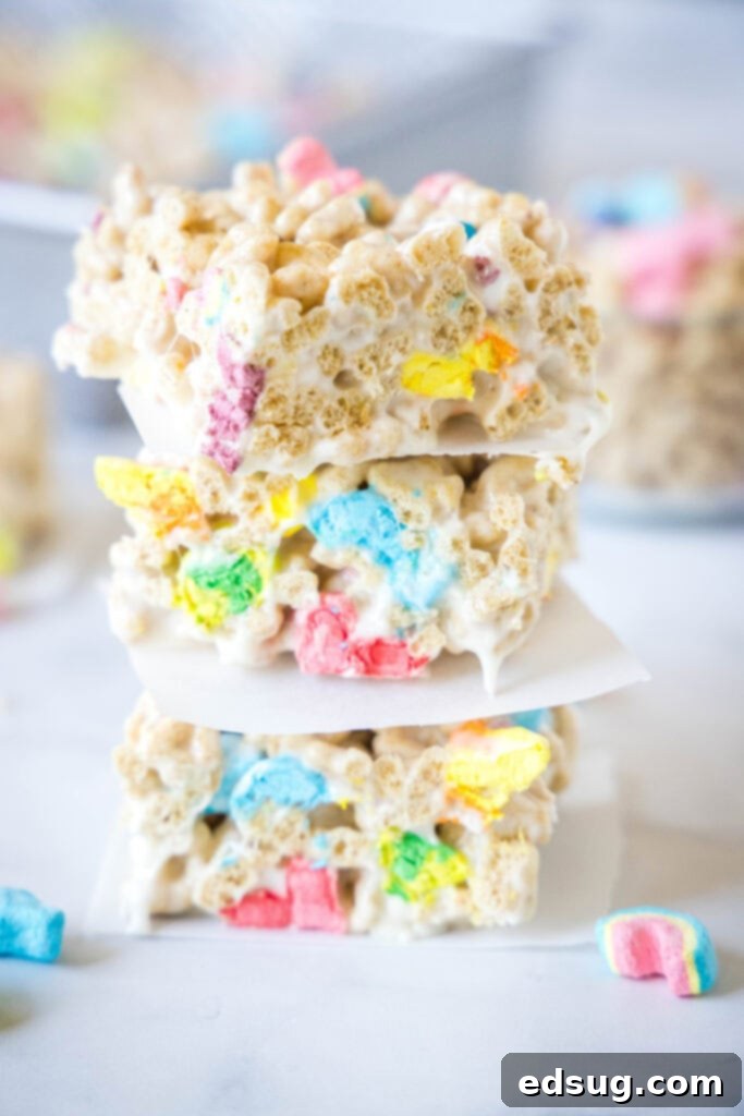 Lucky Charms Rainbow Krispie Delights 2 Stacked gooey Lucky Charms Rice Krispie Treats with colorful marshmallows