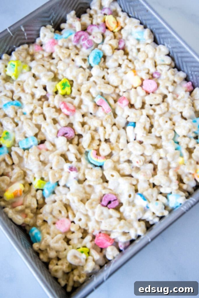 Lucky Charms Rainbow Krispie Delights 4 Lucky Charms Rice Krispie Treats mixture in a baking dish before setting