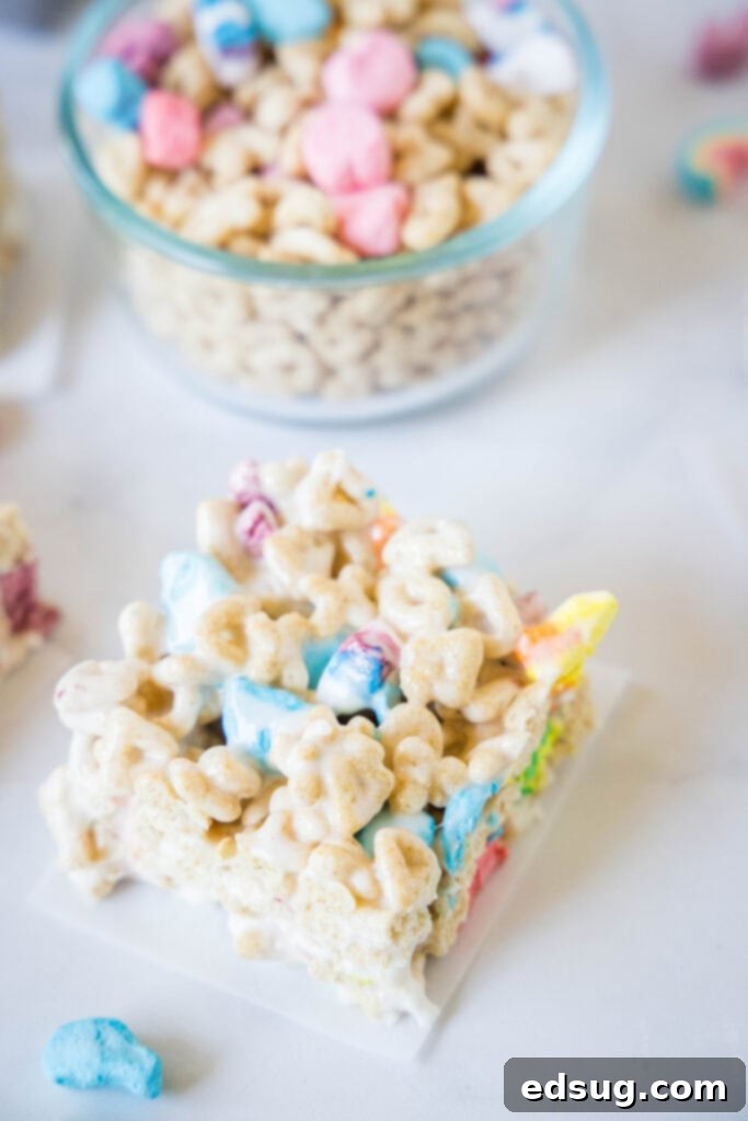 Lucky Charms Rainbow Krispie Delights 5 Lucky Charms Rice Krispie Treats cut into squares on a counter
