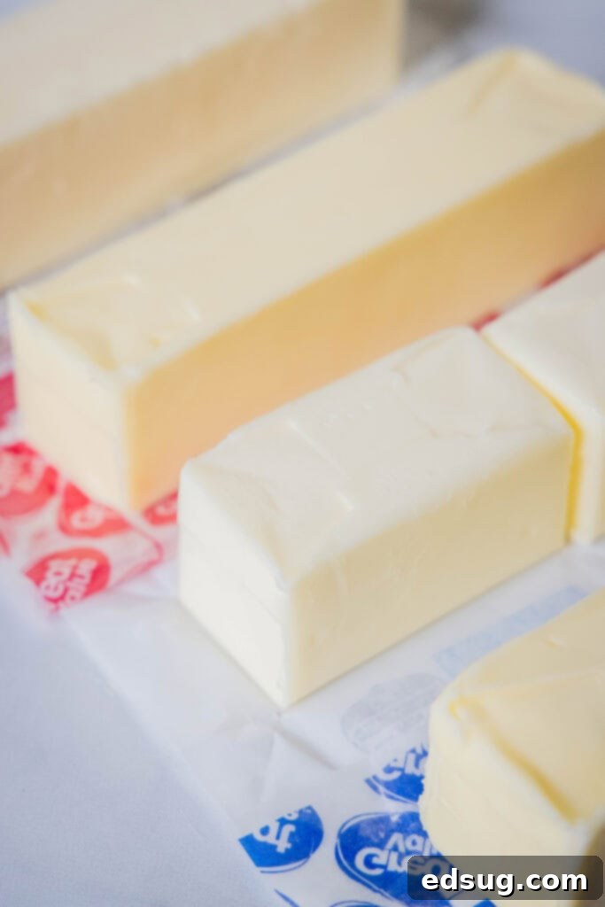 The Butter Dilemma Salted Or Unsalted 5 close up of sticks of butter on a wooden surface
