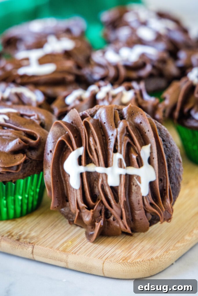 football decorated cupcake on a cutting board