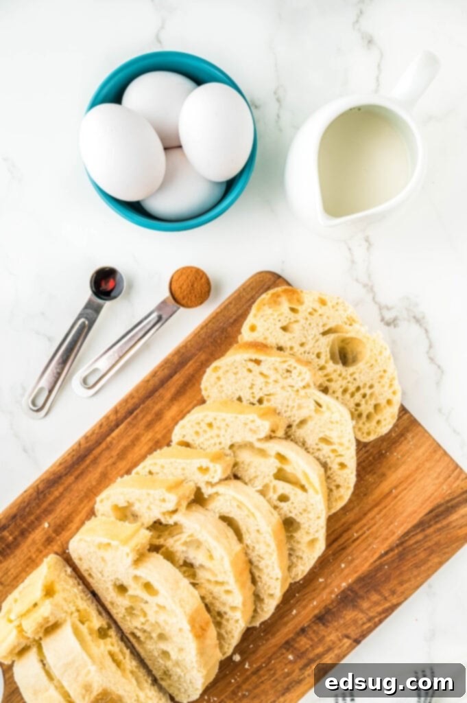Golden Air Fryer French Toast 3 Key ingredients for Air Fryer French Toast laid out on a wooden surface: thick-cut bread, eggs, milk, cinnamon, and vanilla extract.
