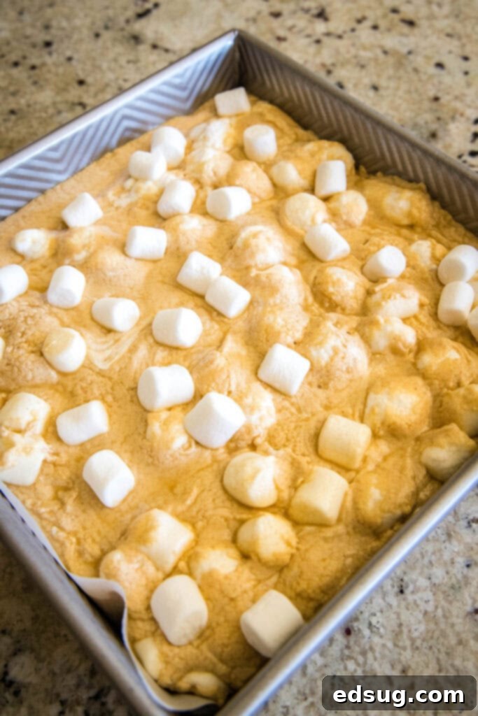 Peanut Butter Marshmallow Fudge 4 Freshly poured peanut butter marshmallow fudge setting in a square baking dish.