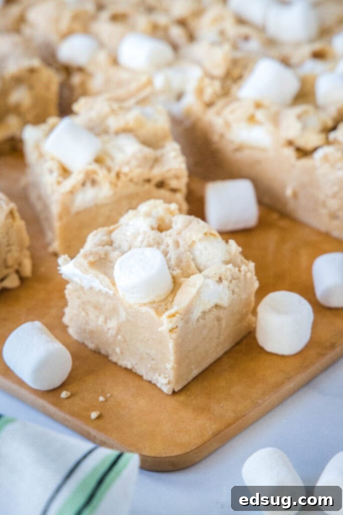 Peanut Butter Marshmallow Fudge 7 An array of peanut butter marshmallow fudge pieces displayed on a wooden cutting board.