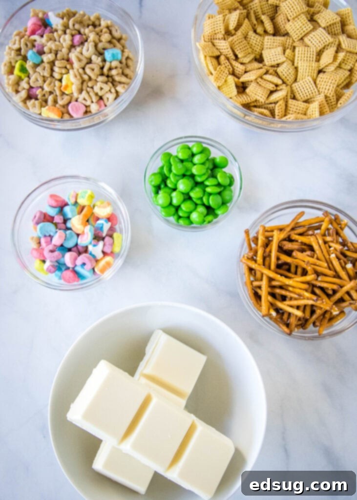 leprechaun bait ingredients laid out, including cereals, pretzels, M&Ms, and white chocolate