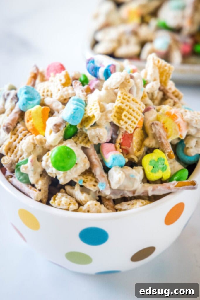 looking down on a bowl of leprechaun bait with chex mix and lucky charms, showing texture