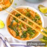 Close-up of Thai Red Curry Soup with chopsticks resting on the bowl.