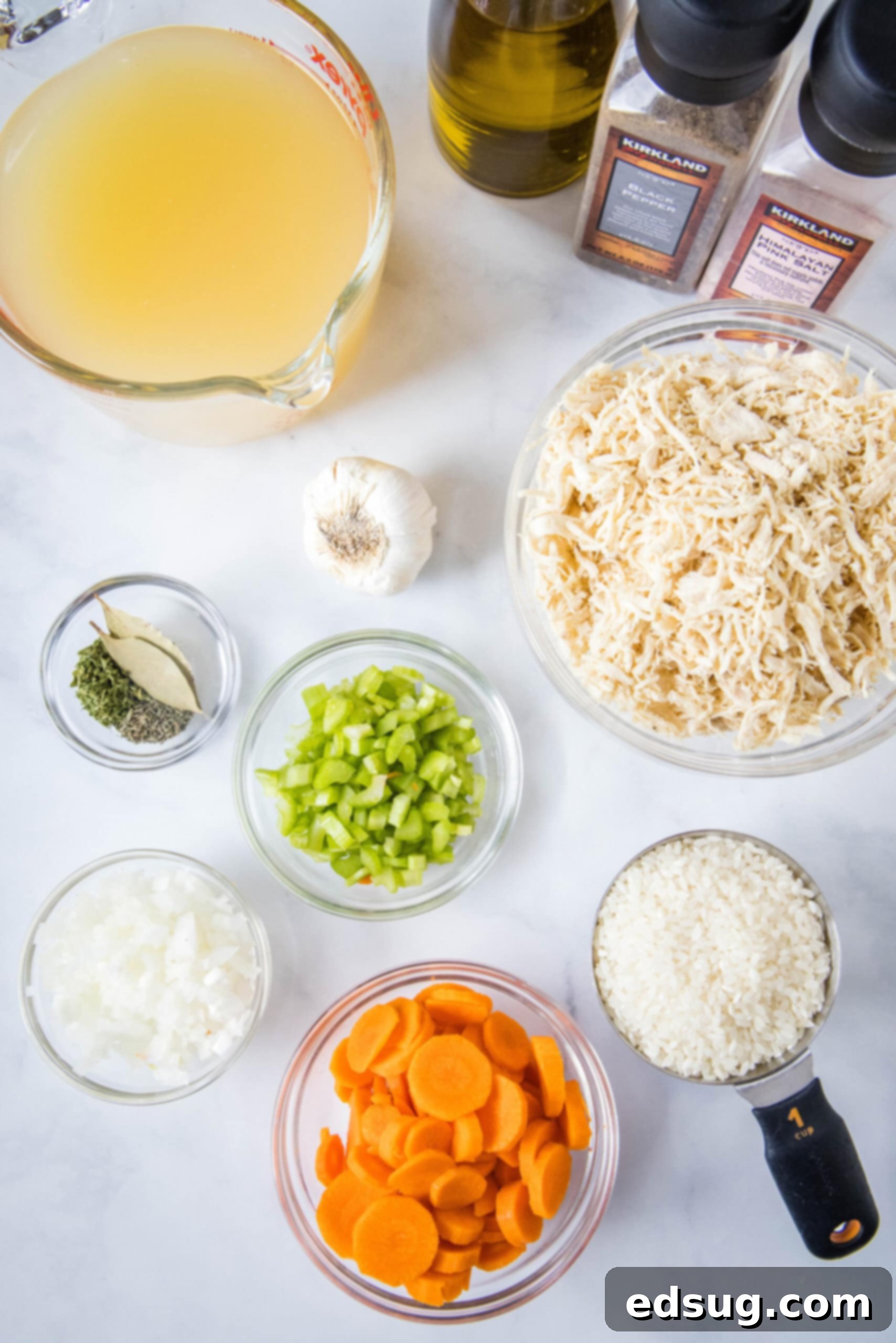 Fresh Ingredients for Chicken Rice Soup: Simple and Wholesome. Fresh ingredients laid out for chicken rice soup: carrots, celery, onion, garlic, chicken breasts, and uncooked rice.