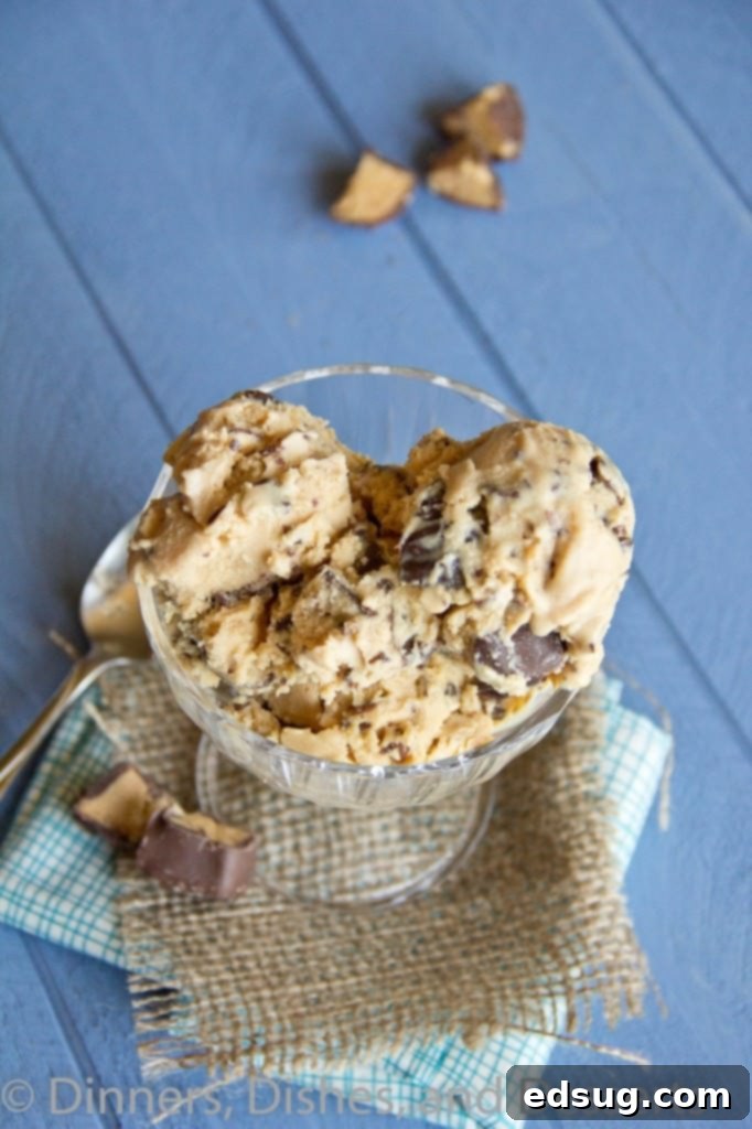 A close-up of creamy peanut butter cup ice cream with visible chunks of chocolate and peanut butter.