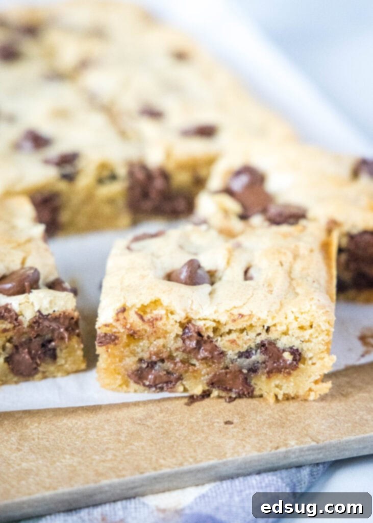 Chewy Golden Chocolate Chip Bars 5 cut chococolate chip blondies on a cutting board