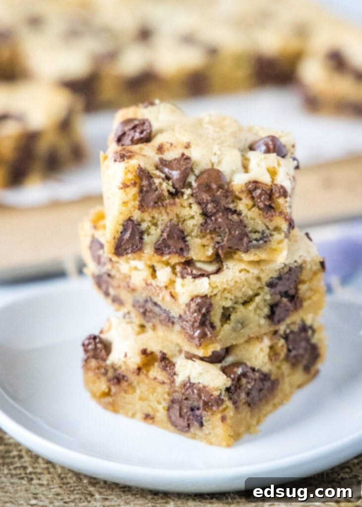 Chewy Golden Chocolate Chip Bars 6 stacked chocolate chip blondies on a white plate