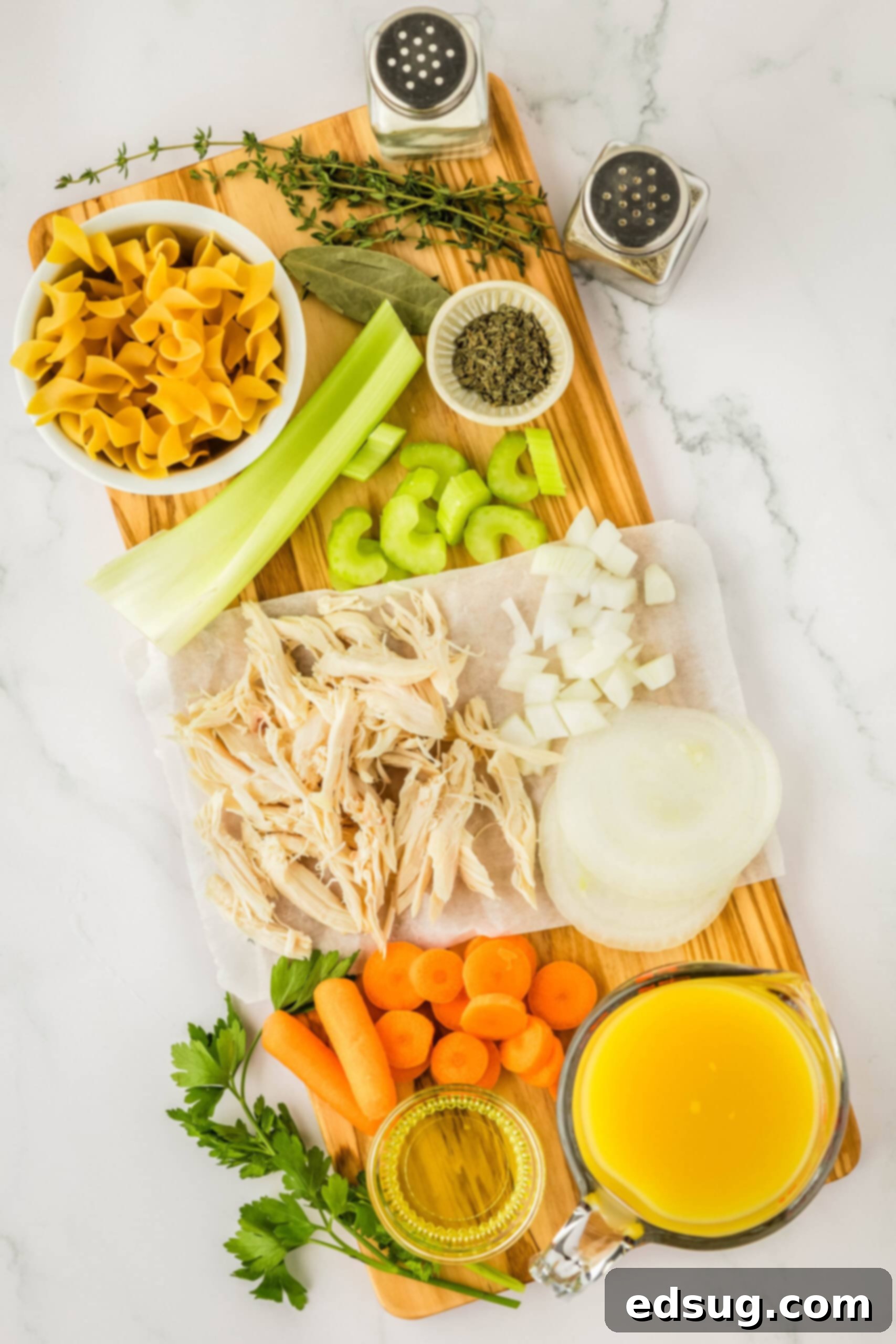 chicken noodle soup ingredients on a board