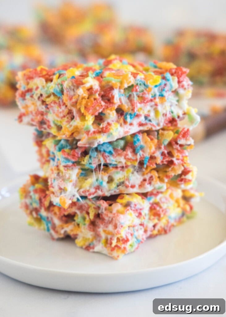 stacked fruity pebbles bars on a white plate