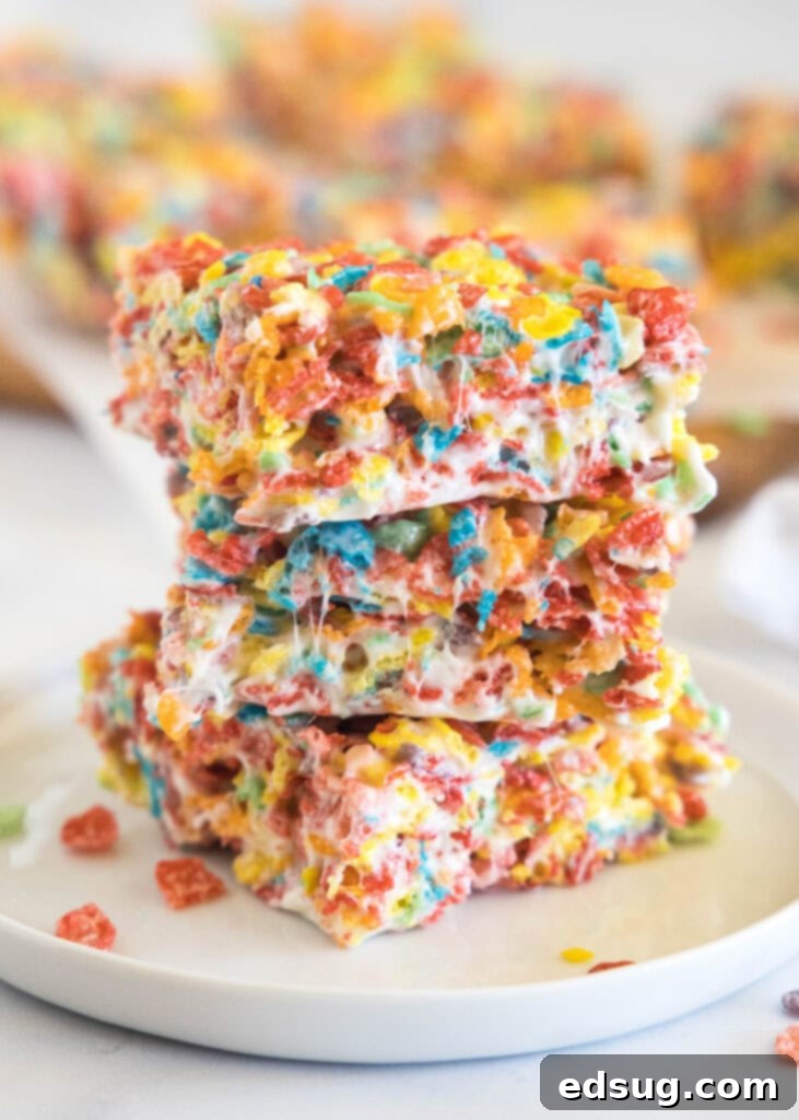 stacked fruity pebbles bars on a white plate