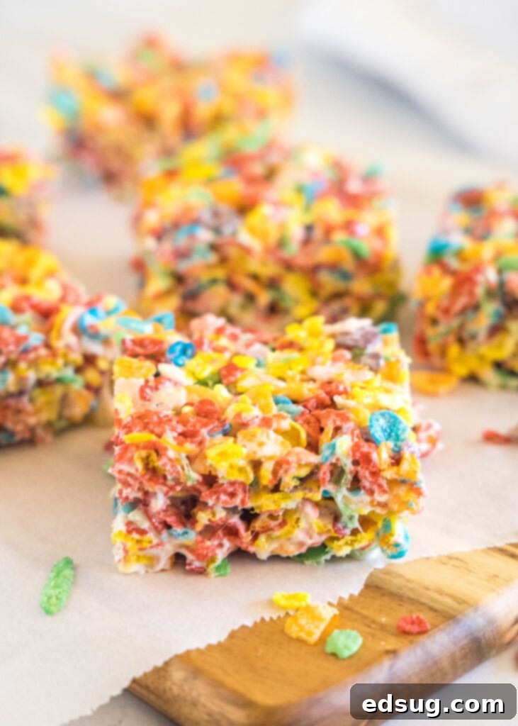 Rainbow Cereal Treats 6 fruity pebbles krispie treats sliced on a cutting board