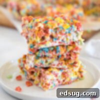Rainbow Cereal Treats 7 cropped close up fruity pebbles bars on a white plate