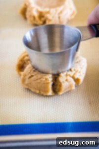 Cocoa Peanut Butter Cloud Cookies 9 using a measuring cup to press down cookie dough