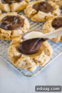 Cocoa Peanut Butter Cloud Cookies 10 spooning ganache into peanut butter cookies
