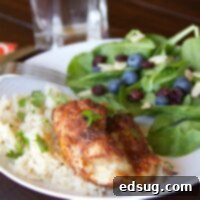 Succulent Spiced Chicken Thighs with Aromatic Garlic Rice 3 spiced chicken thighs with garlicky rice on a plate