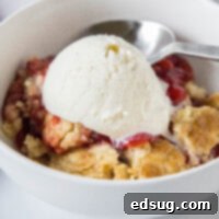 Strawberry Cobbler Delight 7 cropped close up strawberry dump cake in a bowl with ice cream