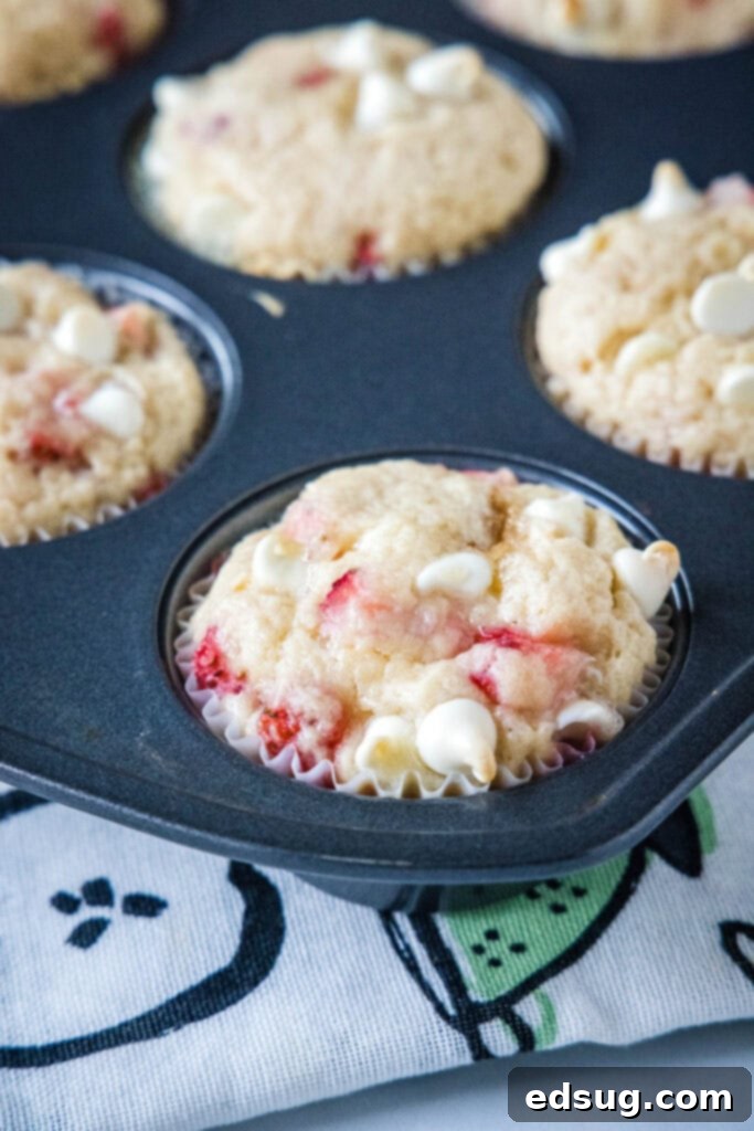 Heavenly Strawberry White Chocolate Chip Muffins 4 strawberry white chocolate chip muffins in a muffin tin