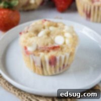 Heavenly Strawberry White Chocolate Chip Muffins 7 cropped close up strawberry white chocolate chip muffin on a plate