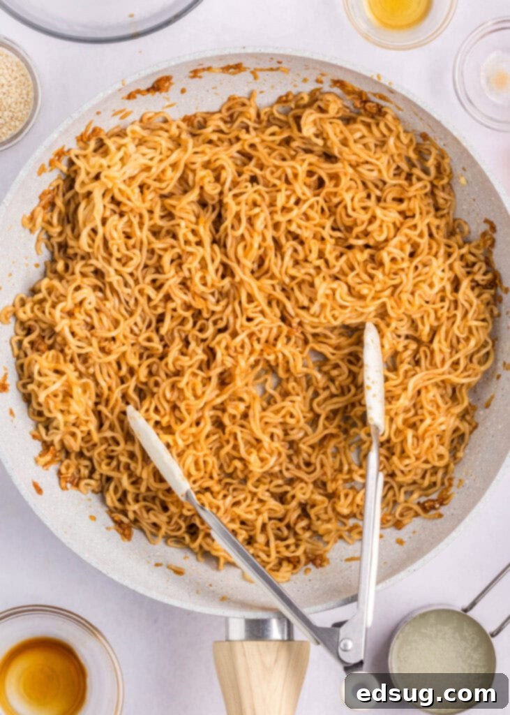 Savory Sesame Noodles 4 adding ramen to sesame noodle sauce in a skillet