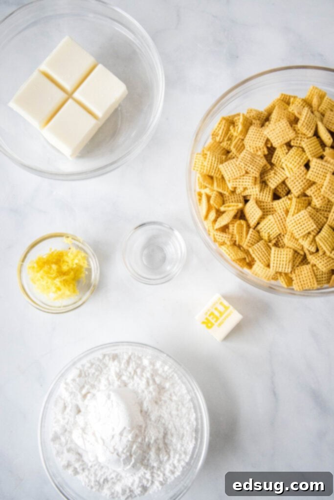 A close-up view of all the simple ingredients laid out for making lemon puppy chow: Chex cereal, powdered sugar, white chocolate, butter, lemon extract, and fresh lemons for zesting.
