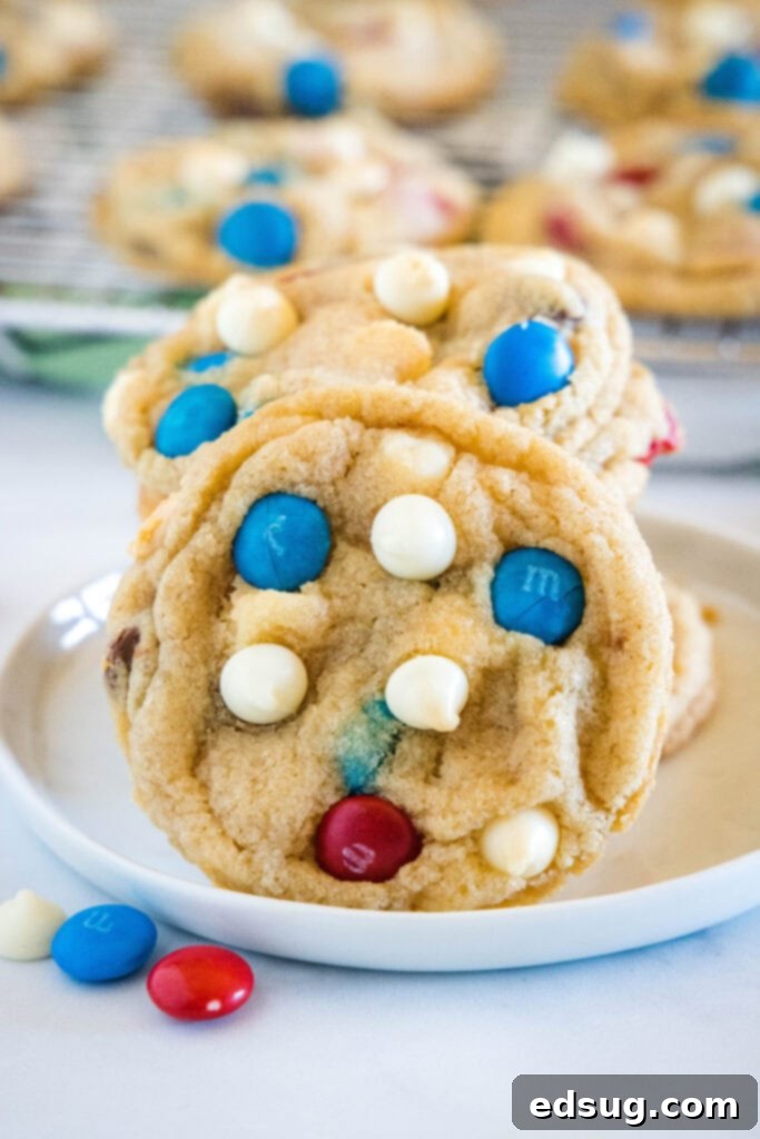 Red, White & Blue Cookies 2 Soft and chewy 4th of July cookies on a white plate, showcasing red, white, and blue M&M's and chips.