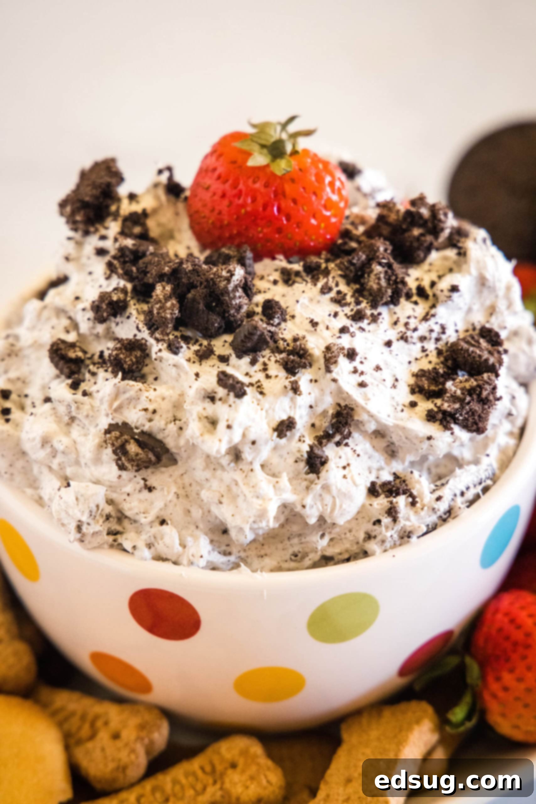 Prepare to be obsessed with Oreo fluff! Make this easy no-bake dessert with 5 ingredients in 5 minutes. It's perfect for dipping! A bowl of Oreo fluff topped with crushed Oreos and a strawberry surrounded by a platter of dippables.